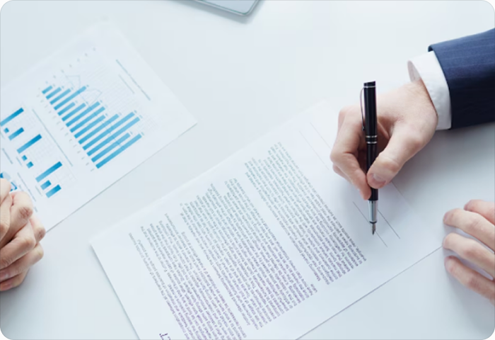 Hand signing a legal document with a pen